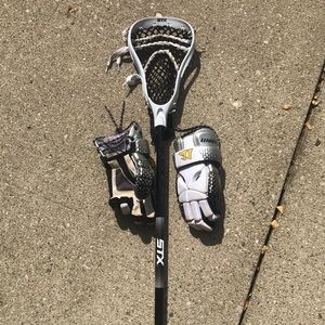STX lacrosse stick and Warrior gloves